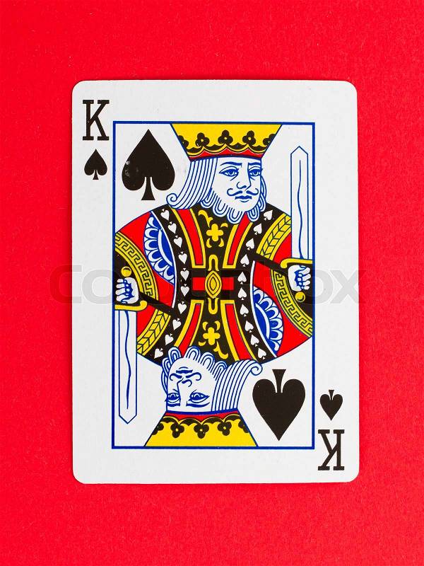 Old playing card king isolated on a red background, stock photo