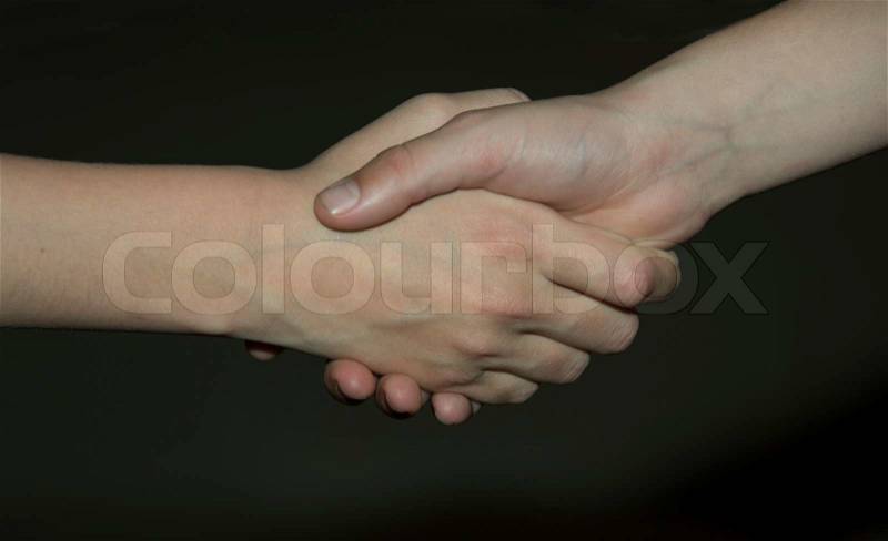 Two children shake hands, stock photo