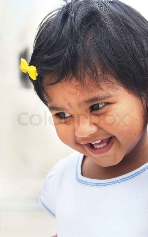 Photo of beautiful and blissful indian baby girl with expressive eyes and photogenic face expressing toddler\'s innocence with a pretty smile The child is of pre school age and is of indian origin, stock photo