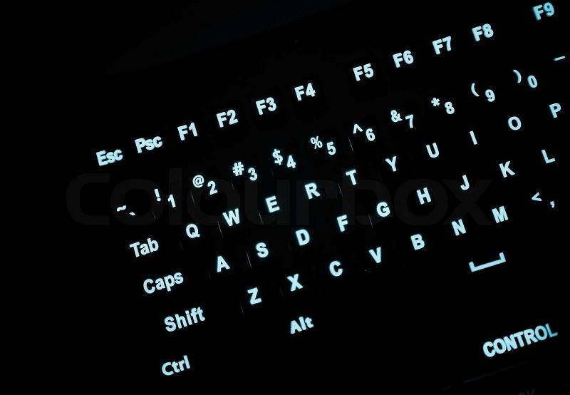 Fragment of illuminated industrial keyboard in the dark, stock photo