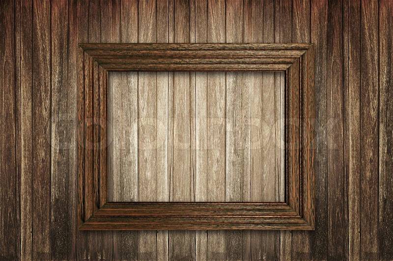 Wooden picture frame on wooden wall, stock photo