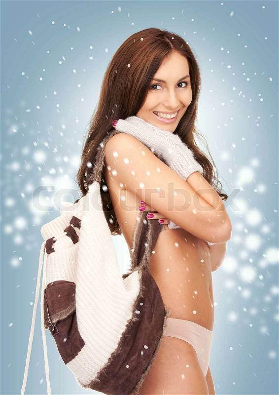 Beautiful woman in mittens with backpack, stock photo
