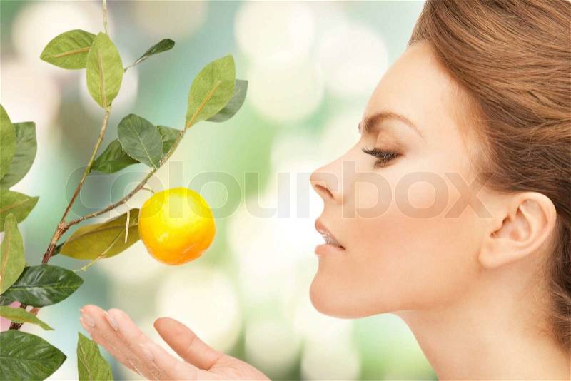 Lovely woman with lemon twig, stock photo