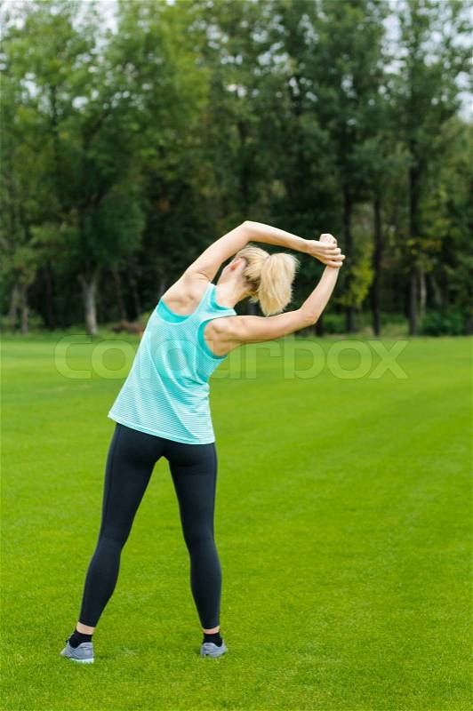 Young woman doing fitness outdoor, stock photo