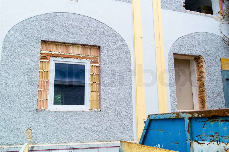 In an old house new windows are bricked restoration and renovation of old buildings, stock photo