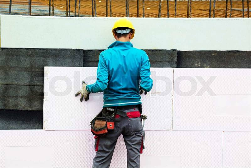 Construction workers and insulation, stock photo
