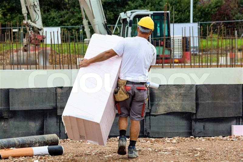 Construction worker with insulation, stock photo