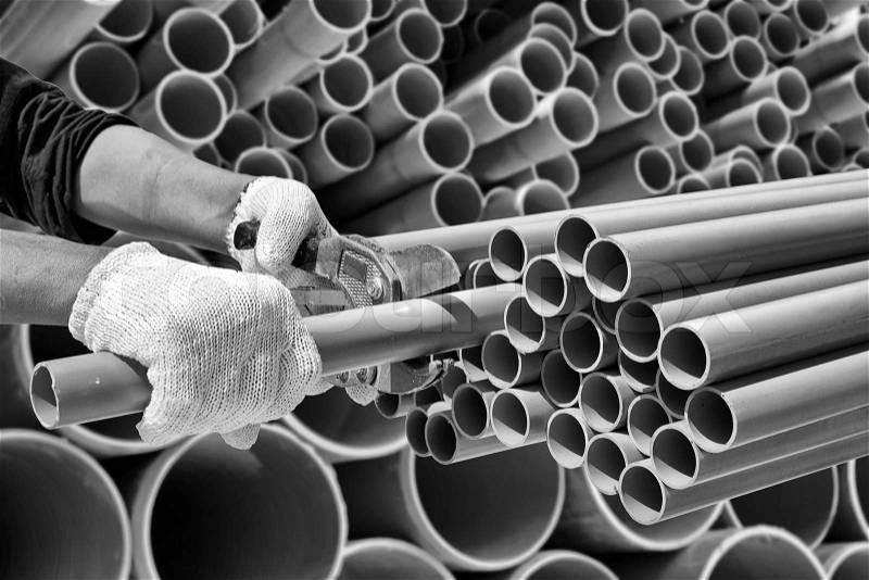 Worker cut pvc pipe in construction site, stock photo