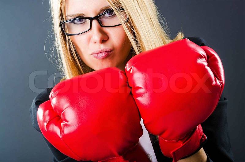 Woman boxer in dark room, stock photo