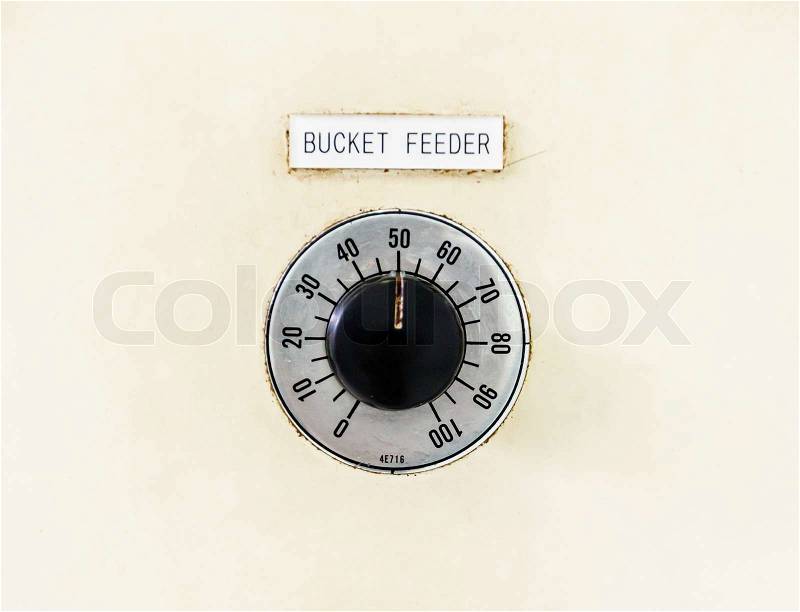 Rusty industrial bucket feeder button control panel, stock photo