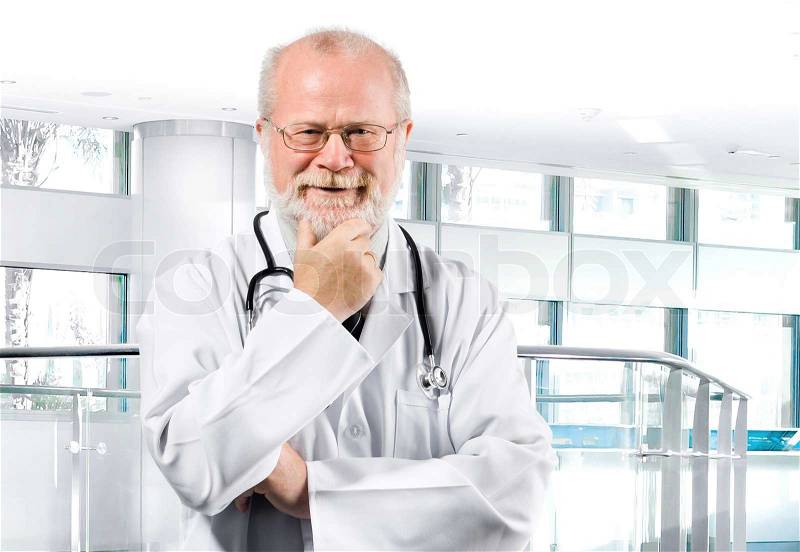 Portrait of pensive senior medical doctor isolated over clinic background, stock photo