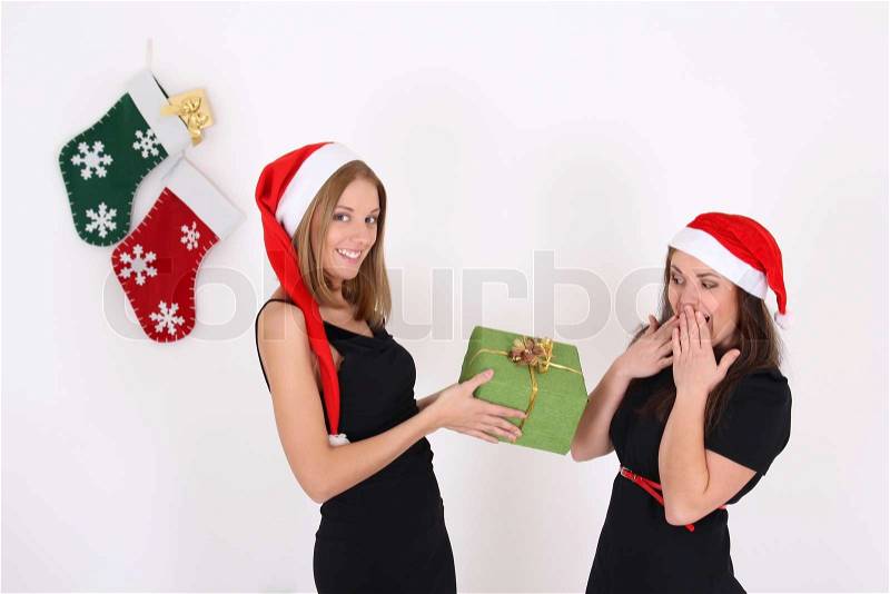 The girl gives a gift to a friend, stock photo