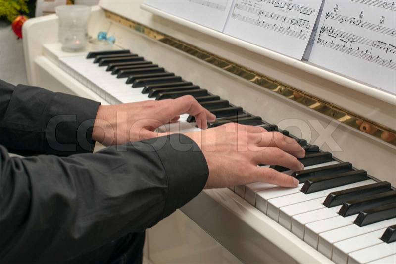 Hands on the piano, stock photo