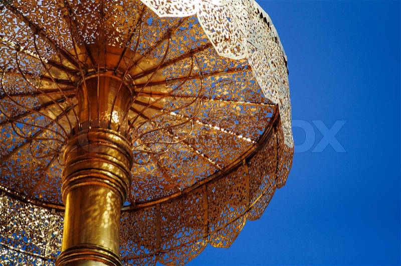 Golden Tiered Umbrella in clear sky, stock photo