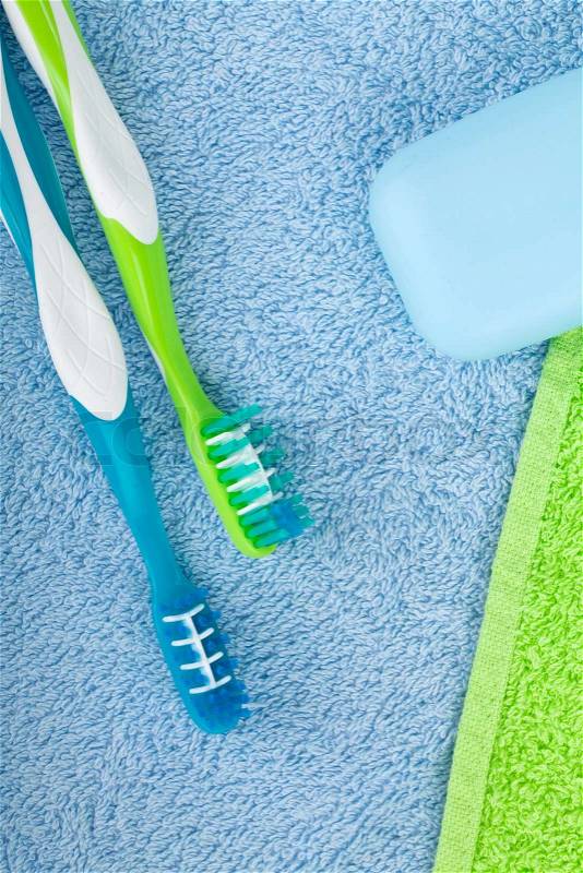 Toothbrushes and soap over towels, stock photo