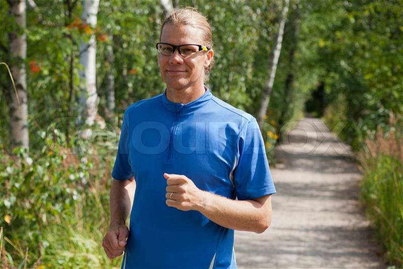 Trail runner in summer, stock photo