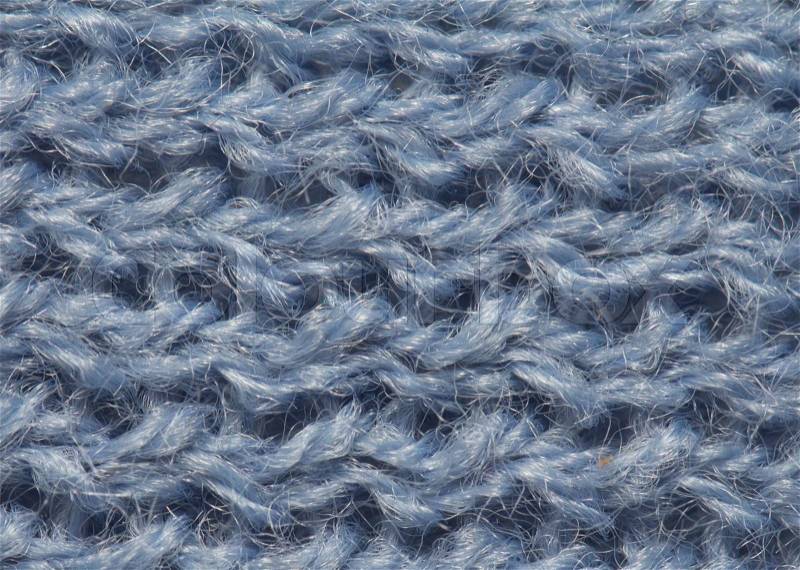 Closeup of seamless blue knitted fabric texture, stock photo