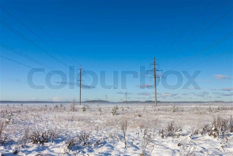 Electric power transmission in the field winter, stock photo