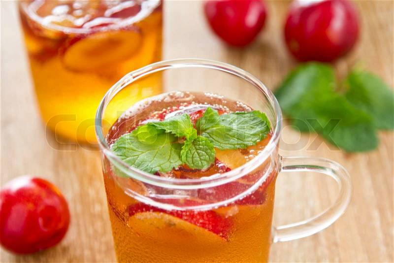 Plum juice with piece of fresh plum and mint, stock photo