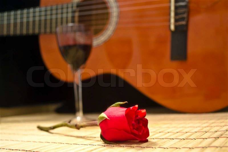 Romantic evening wine glass of vine and classical guitar love theme candle dinner, stock photo