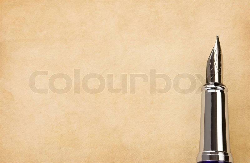 Ink pen and parchment background, stock photo
