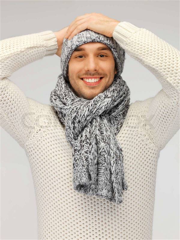 Handsome man in warm sweater, hat and scarf, stock photo