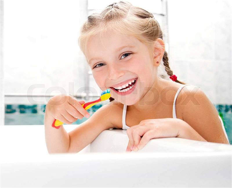 Little girl brushing teeth, stock photo
