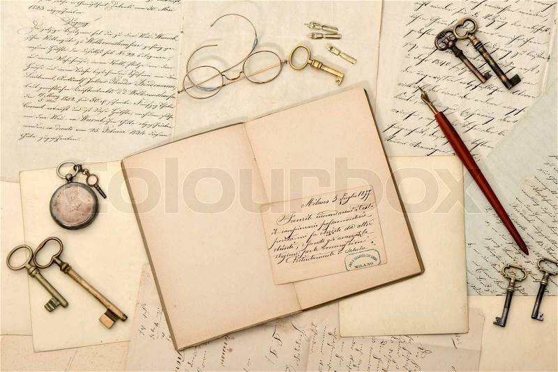 Open book, vintage accessories, old letters, stock photo