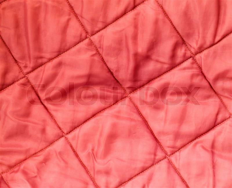 Closeup background texture of quilted red blanket fabric, stock photo