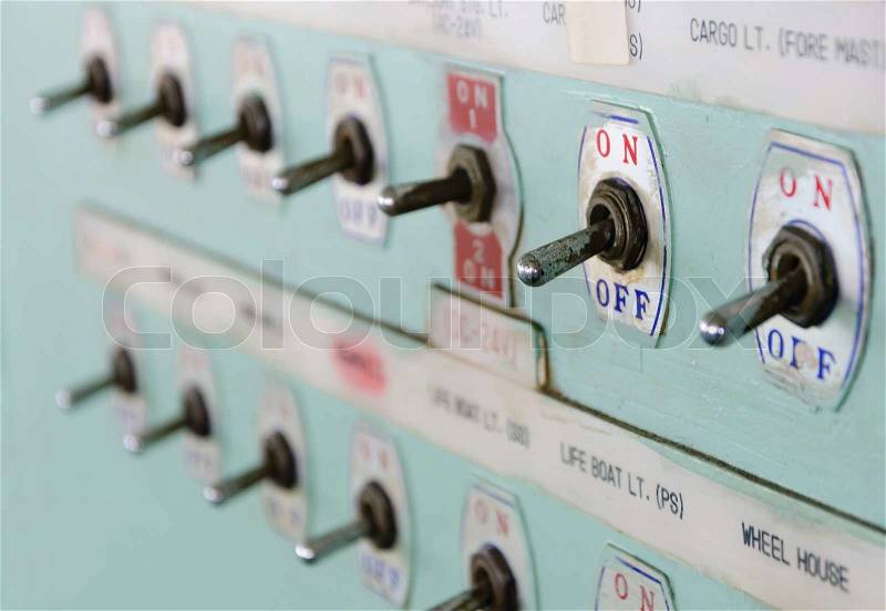 Close up shot of toggle switch on off button panel on cargo vessel, stock photo