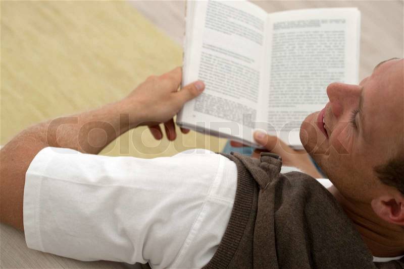 Man reading a good book, stock photo