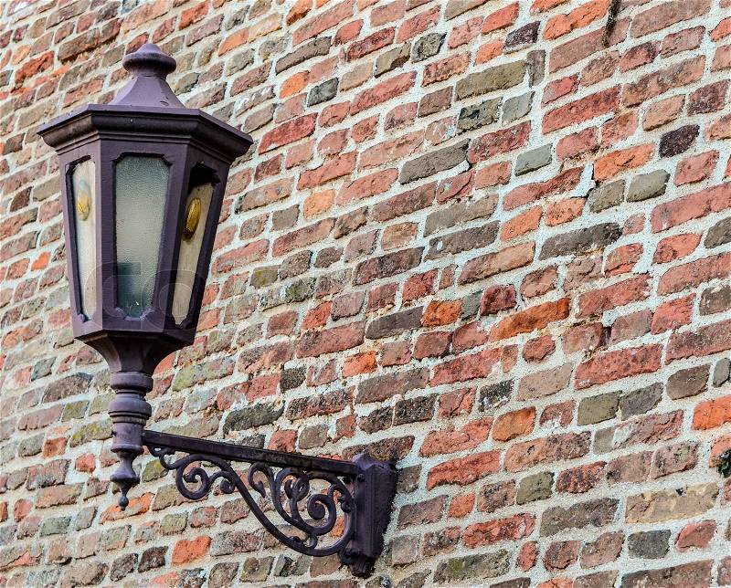 Old street lamp on brick wall, stock photo