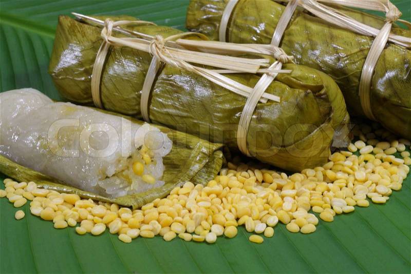 Rice and beans steamed in banana leaf, stock photo