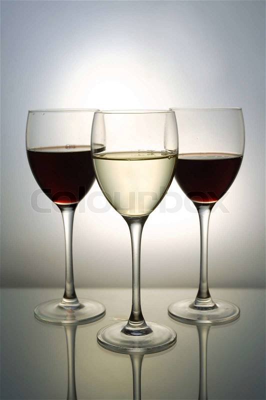 Three glasses with red and white wine, stock photo