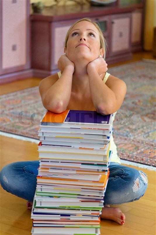 Student with a stack of books and computers, stock photo