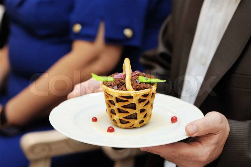 Man holding plate with tasty dessert, stock photo