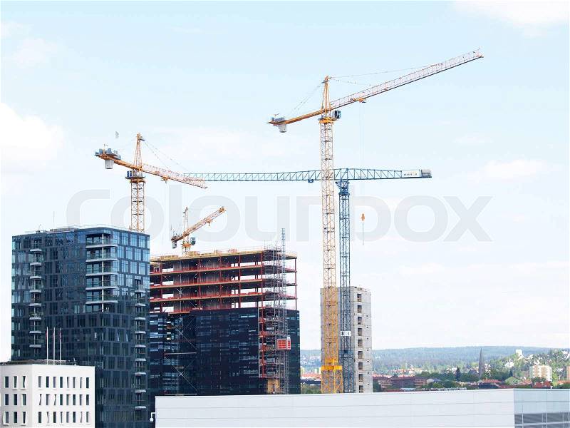 Construction site overview in a city, towards blue sky, stock photo