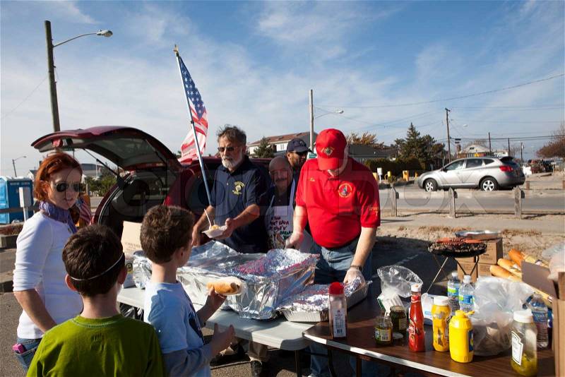 NEW YORK - November 12: Volunteers and workers helping people after Hurricane Sandy inthe flooded neighborhood at Breezy Point in Far Rockaway areaon November 12, 2012 in New York City, NY, stock photo