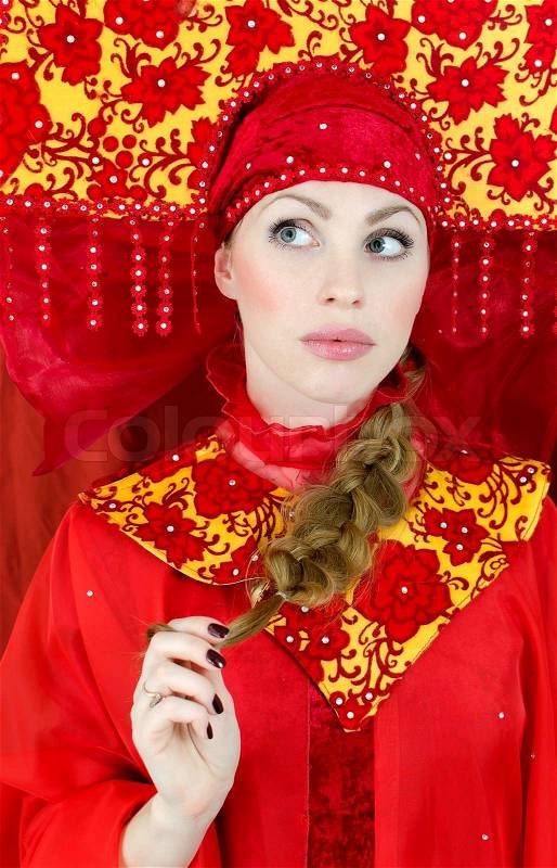 Woman in russian traditional clothes thinking, stock photo