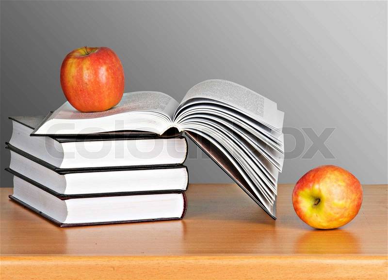 Apple on pile of books, stock photo