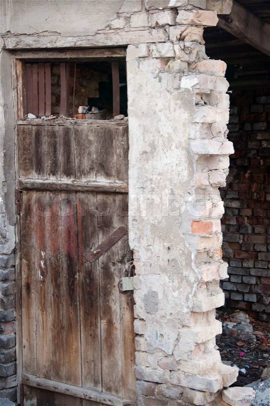 View of an old wooden door in ruins, stock photo
