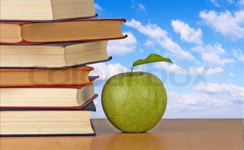Green apple and books, stock photo