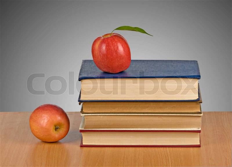 Apple on book on grey background, stock photo