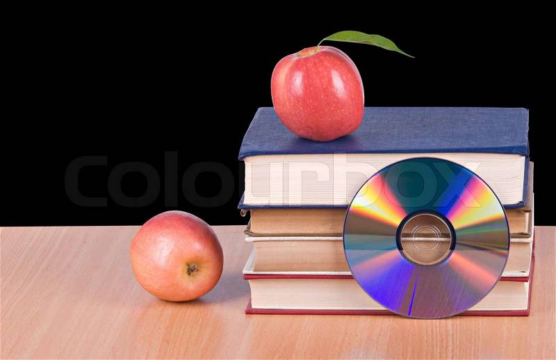 Apples, dvd, andbooks assymbols of transition fron old to new ways of learning, stock photo