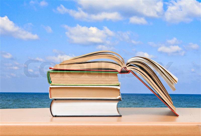 Open book on desk and sea, stock photo