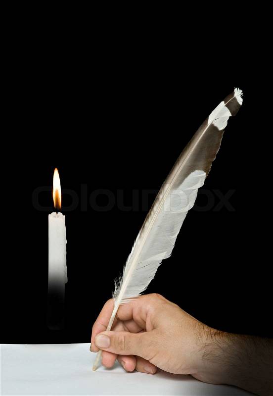 Writer writing with feather and candle, stock photo