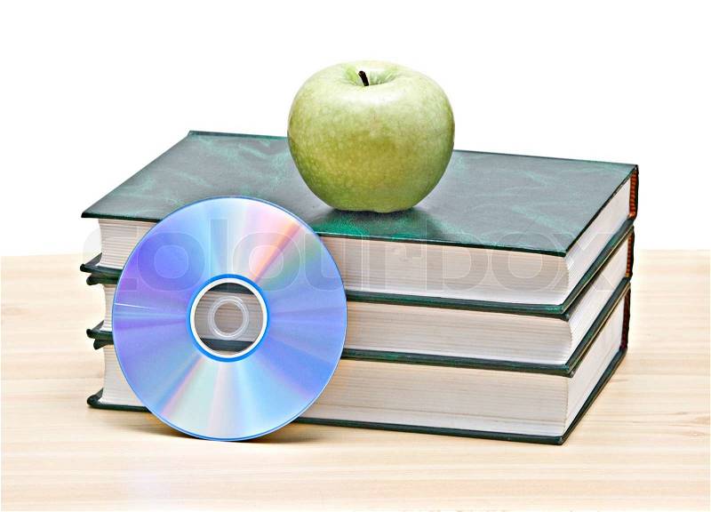 Apple, dvd, and books as a symbol of transition fron old to new mways of learning, stock photo