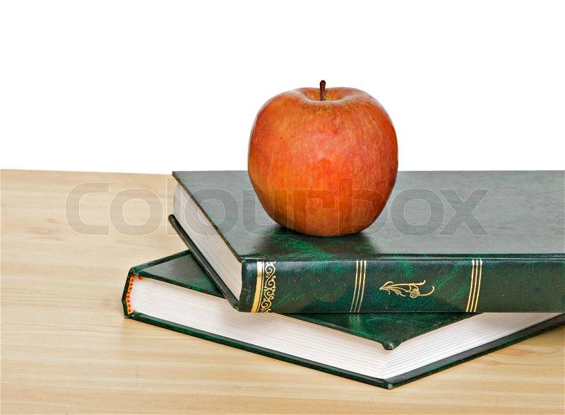 Red apple on books on desk, stock photo