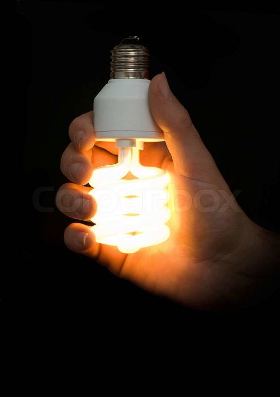 Energy-saving lamp in hand, stock photo
