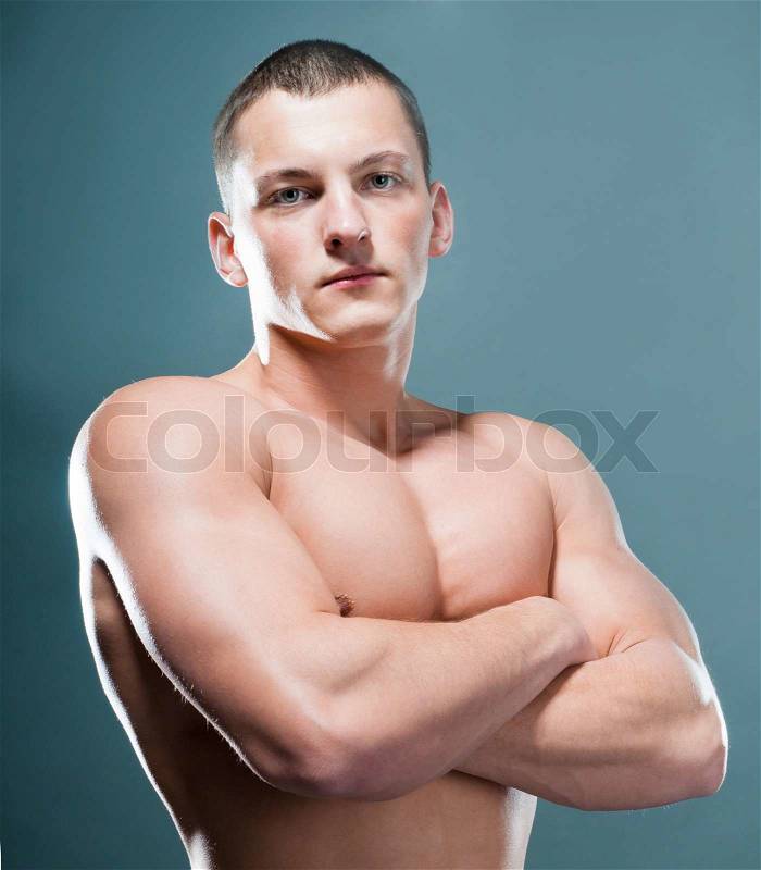 Strong athletic man on grey background, stock photo